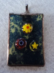 Pendentif bleu parsemé de jaune avec 3 millefioris fondus jaune, bleu et orange, monté en Tiffany